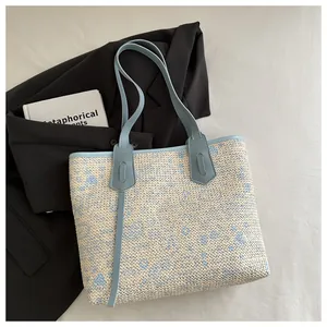 Close-up of woven tote bag texture with light blue floral pattern on fabric background