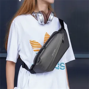 Close-up of a dark grey waterproof sling bag with adjustable strap and sport engraving