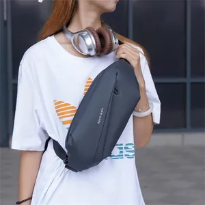 Detail of grey crossbody sling bag made of water-resistant fabric with adjustable strap