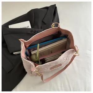 Pink lace textured tote bag interior view showing large storage capacity for books
