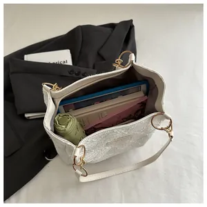 Interior view of white textured tote bag showing large capacity for tablet and umbrella