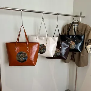Ethnic embossed tote bags in four colors with vintage circular medallion details