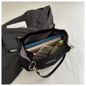 Interior view of black tote bag showing organized large capacity and brand detail