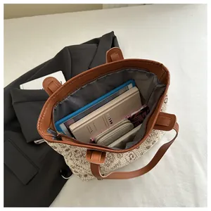 Close-up of woven tote bag interior showing large capacity for laptop and daily essentials