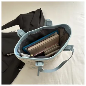 Top view of woven tote bag interior showing large capacity for tablet and accessories