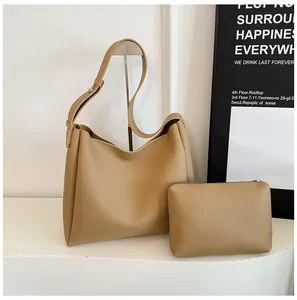 Detail of khaki hobo tote bag set with matching small zipper pouch on white surface