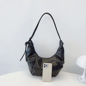 Retro black pleated hobo bag with knotted strap detail and spacious moon-shaped design