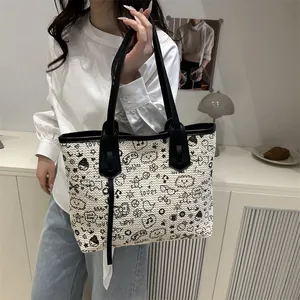 Fashionable woven tote bag with cartoon graffiti patterns and black leather trim
