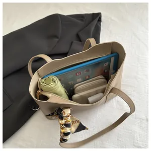Top-down detail view of spacious tote bag interior with iPad, umbrella and daily essentials