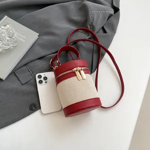 Mini red leather and beige canvas bucket bag with zip closure and top handle