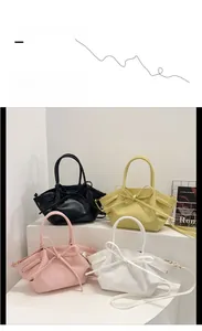 Showcase of four solid colored bow-knot bat tote bags in black, yellow, pink and white