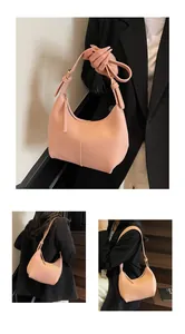 Detailed view of pink hobo bag with adjustable strap and golden metal hardware