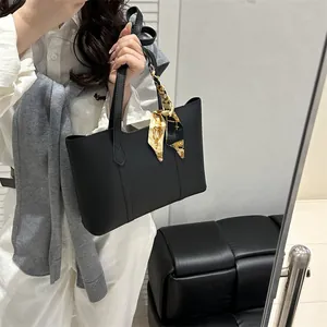 Classic black leather tote bag for women with a silk scarf, perfect for work commuting