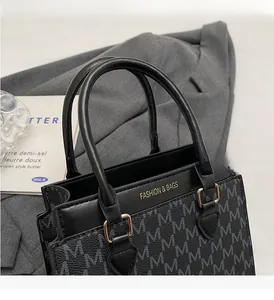 Close-up of vintage monogram tote with leather texture and gold hardware details