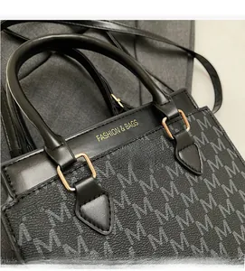 Detailed close-up of patterned handbag showing gold hardware and Fashion & Bags lettering