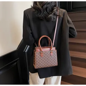 Detailed shot of brown vintage printed handbag with fashion and bags golden text