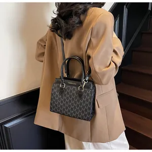 Detail showing vintage letter print handbag with top handles and fashion text branding