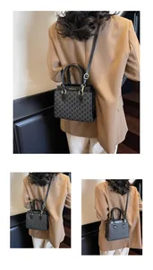 Detail view of black vintage Boston bag with M-pattern print and adjustable strap