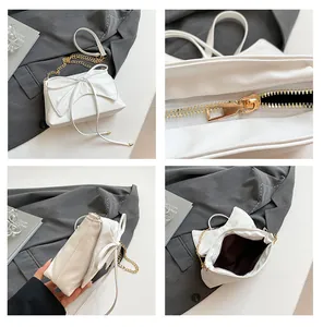 Détails de l'intérieur et de la chaîne dorée du sac blanc élégant avec nœud papillon