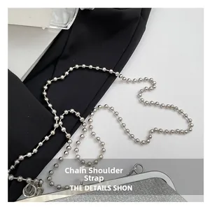 Detailed view of silver sequin bag with polished round bead chain and metal hook