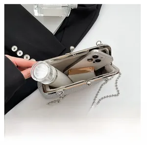 Internal view of silver sequin evening clutch showing space for smartphone and makeup