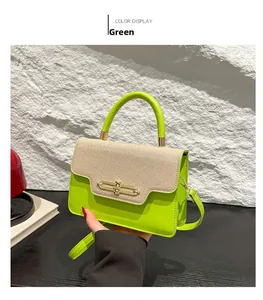 Detail of green woven texture flap and metallic buckle on small crossbody bag
