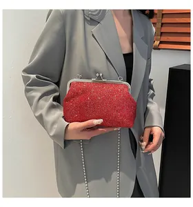 Detail of red sequined clutch bag with silver kiss-lock frame and elegant pearl chain