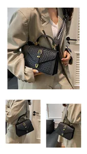 Detail of black woven leather flap bag with gold clasp and patterned strap