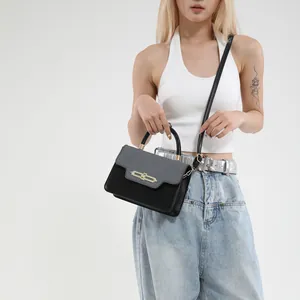 Fashionable contrast color shoulder bag with grey fabric flap and black leather body