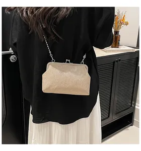 Detail of champagne gold sequin evening bag with elegant chain strap and vintage metal clasp