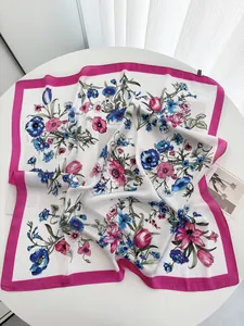 Detail view of floral satin scarf with pink border and vintage botanical print