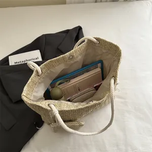 Grote strooien draagtas met katoenen touwhandvatten en ruim interieur in een casual setting