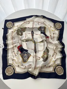 Detail of silk square scarf featuring nautical chain patterns and equestrian motifs