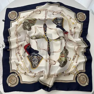 Detail of silk square scarf featuring nautical chain patterns and golden horse buckles