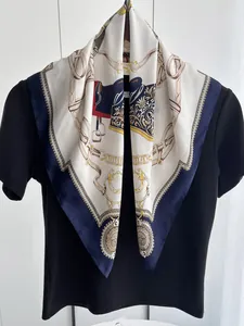 Detail of silk square scarf featuring equestrian chain and horse saddle patterns