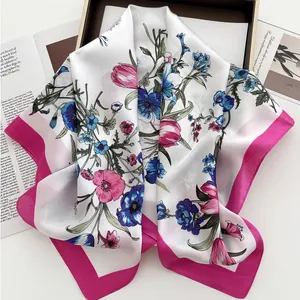 Detail of silk-like floral square scarf with pink borders and elegant tulip patterns