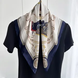Detail showing the elegant horse bridle pattern and golden chains on the ivory silk scarf