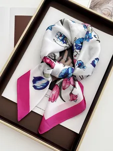 Detail of silk-like floral square scarf with pink borders on a fashion magazine