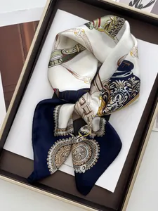 Classic equestrian chain print silk scarf elegantly folded in a premium gold gift box
