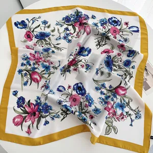 Detailed close-up of butterfly floral print silk scarf with stylish mustard yellow border