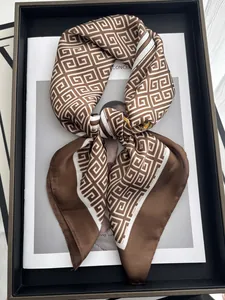 Macro detail of silk scarf with classic geometric Greek key pattern in brown and white