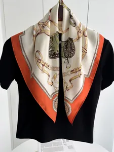 Close-up of silk scarf with equestrian horse chain patterns and orange borders