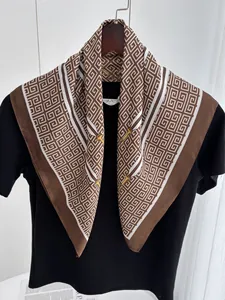 Detail of elegant chain and bit pattern on a luxurious brown and white silk scarf