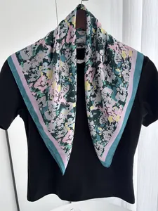 Detailed texture of colorful floral silk square scarf with contrasting purple border