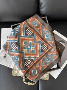 Detail of silk-feel scarf with geometric patterns on a decorative tray