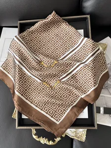 Detail of elegant silk square scarf with geometric G pattern and golden horsebit motif