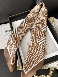 Detail of silk scarf with horsebit and geometric patterns over vintage background