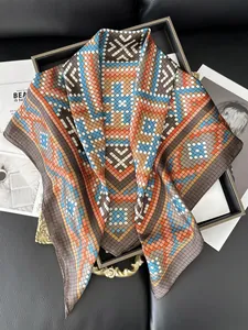 Detail of printed silk scarf with geometric grid pattern on a vintage decorative tray