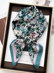 Detailed close-up of abstract floral print silk scarf with polished satin texture