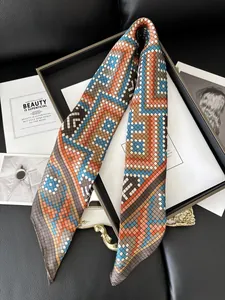 Detailed close-up of silk neck scarf with geometric patterns and orange-blue print